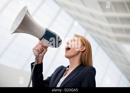 Geschäftsfrau in Megaphon schreien Stockfoto