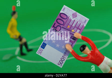 (DATEI - ILLUSTRATION) Archiv zur Veranschaulichung vom 2. Dezember 2009 zeigt eine Tipp-Kick-Figur mit Spielgeld in Form von einem 500-Euro-Schein in Frankfurt Main, Deutschland. Foto: Uwe Anspach Stockfoto