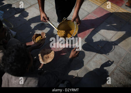 Sep 24, 2012 - Delhi, Indien - A volunteer dient Linsen an am frühen Morgen Fütterung in Delhi, Indien. (Kredit-Bild: © Michael Francis McElroy/ZUMAPRESS.com) Stockfoto