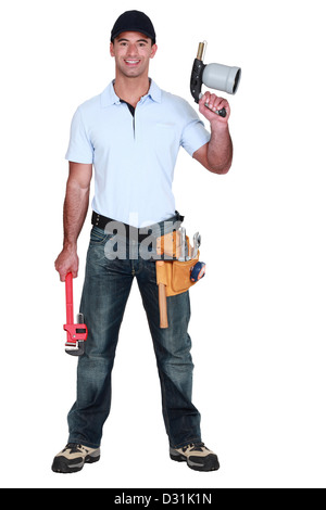 Ein Klempner mit einer schwingenden Fackel und einen Schraubenschlüssel. Stockfoto