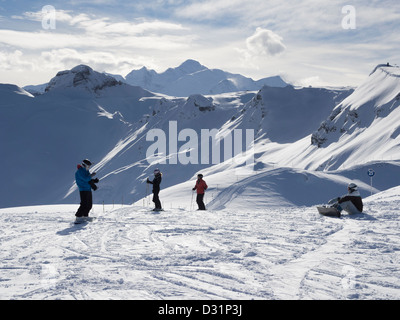 Skifahrer und Snowboarder auf der Piste im Skigebiet Le Grand Massif mit Blick auf Mont Blanc in den französischen Alpen. Grands Vans Flaine Frankreich Stockfoto