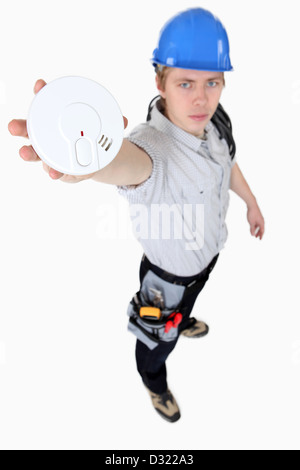 Builder Holding smoke alarm Stockfoto