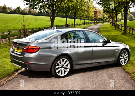 BMW 5er Reihe geparkt über Landstraße, Winchester, UK Stockfoto