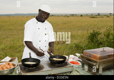 Koch bereitet ein Buschfrühstück in Masai Mara National Reserve, Kenia Stockfoto