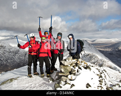 Eine Gruppe von Winter Bergsteiger auf dem Gipfel des Buachaille Etive Beag in Glencoe im schottischen Hochland Schottland, Vereinigtes Königreich Stockfoto