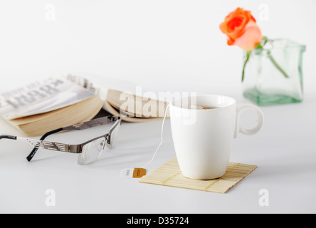 Tasse Tee mit Buch und lesen Gläser Stockfoto