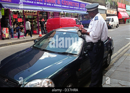 Traffic Warden ticketing Auto im Zentrum von London Stockfoto