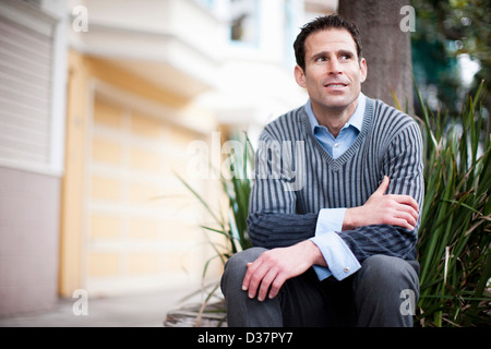 Geschäftsmann von Baum auf Straße Stockfoto