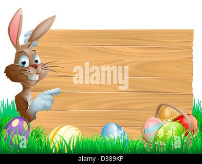 Ostern Hase Charakter zeigt auf ein leeren Zeichen mit Platz für Text. Umgeben von bemalten Schokoladeneier Stockfoto