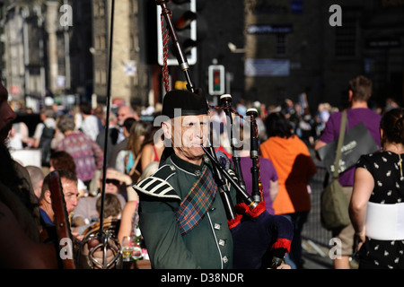 Ein Musiker spielt Dudelsack auf der Royal Mile während des Edinburgh Festival Fringe, High Street, Royal Mile, Schottland, Großbritannien Stockfoto