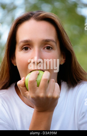 Frau zu essen Apfel im freien Stockfoto