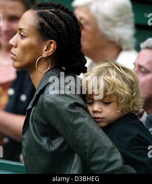 (Dpa) - Elias Baltasar, der jüngste Sohn von Boris Becker, kuschelt auf der Rückseite seiner Mutter Barbara Becker, Beckers Ex-Frau, wie sie das Tennisspiel von Boris Becker gegen Michael Stich in Halle, Deutschland, 8. Juni 2003 zu sehen. Stockfoto