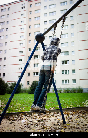 Berlin, Deutschland, ein Mädchen auf einem Spielplatz in Marzahn-Hellersdorf schwingen Stockfoto