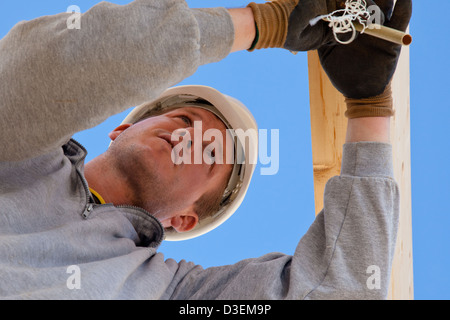 Real-Generator bei der Arbeit mit Dachkonstruktion auf der Baustelle Stockfoto