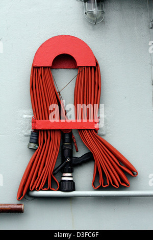 Blick auf einen roten Feuerwehrschlauch eingewickelt auf einem Boot. Stockfoto