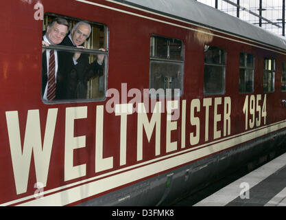 (Dpa) - Hartmut Mehdorn (L), Vorstandsvorsitzender der Deutschen Bahn (DB, Deutsche Bahn) und Franz Beckenbauer, Leiter des 2006 FIFA World Cup Organisationskomitee, schauen aus dem Fenster des ursprünglichen Zuges mit denen der ersten deutschen Weltmeister 1954 das Land in Berlin, Deutschland, 7. Dezember 2004 tourte. Die Deutsche Bahn als letzte nationale Sponsor ausgewählt wurde die Stockfoto