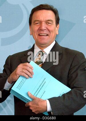 (Dpa) - stellt Bundeskanzler Gerhard Schroeder mit dem Jahresbericht von Deutschlands "Wise Men" erhielt er in Berlin, 12. November 2003. Laut dem Bericht der Berliner Gremium von unabhängigen Wirtschaftsberater, die deutsche Wirtschaft wächst von bis zu eine bescheidenen 1,7 Prozent im kommenden Jahr die Regierung geplanten Steuersenkungen voraussichtlich nur eine kleine wirtschaftliche Impulse zu generieren. Th Stockfoto