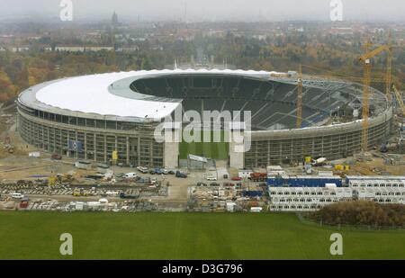 (Dpa) - ein Blick auf das Olympiastadion in Berlin, 7. November 2003. Das Stadion, das für die Olympischen Spiele in Berlin 1936 erbaut worden war, wird derzeit renoviert und ein Dach über den Grand-Ständen wird zur Vorbereitung des Stadions für die Fußball-WM in Deutschland 2006 hinzugefügt. Stockfoto
