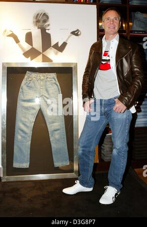 (Dpa) - US-Mode-Designer Tommy Hilfiger stellt neben einer Jeans von Marilyn Monroe, in seinem Laden am Kuerfuerstendamm in Berlin, 14. Oktober 2003. Im Shop eröffnet er eine Ausstellung von Jeanswear entworfen von Berühmtheiten wie Ozzy Osbourne, Arnold Schwarzenegger und Whoopi Goldberg. Die Jeanswear werden später für einen guten Zweck versteigert. Stockfoto