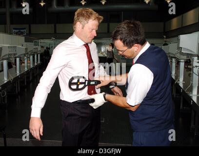 (Dpa) - Bayern München Torwart Oliver Kahn wird vom Security-Personal am Flughafen in München, Deutschland, 14. September 2004 überprüft. Bayern Reisen nach Israel für die UEFA Champions League Zusammenstoß mit Maccabi Tel Aviv Ramat-Gan-Stadion in Tel Aviv, Israel, 15. September 2004 stattfindet. Stockfoto