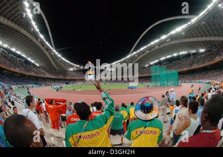 (Dpa) - Happy äthiopisches fans Welle Flaggen zur Unterstützung ihres Landes Athleten während der Frauen-5000 m-Finale, genießen sie den Panoramablick über Olympiastadion in Athen, 23. August 2004. Stockfoto