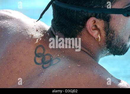 (Dpa) - ein unbekannter Schwimmer Sport ein Tattoo von den Olympischen Ringen auf dem Rücken, nimmt Teil an einer Schulung am Olympischen Pool in Athen, 13. August 2004. Die Olympia-Schwimmhalle Wettbewerbe startet am Samstag, 14. August. Stockfoto