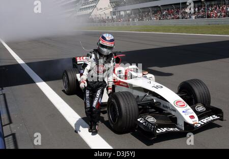 (Dpa) - japanische Formel 1 Fahrer Takuma Sato verlässt seine BAR-Honda-Rennwagen nach Triebwerkausfall während der Europäischen F1 Grand Prix auf dem Nürburgring Rennen verfolgen, Deutschland, 30. Mai 2004. Stockfoto