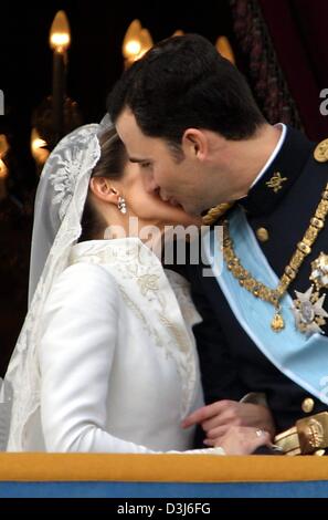 (Dpa) - spanische Kronprinz Felipe und seine Frau Letizia Ortiz küssen einander, wie sie auf dem Balkon des königlichen Palastes nach ihrer Hochzeit am Almudena-Kathedrale in Madrid, Spanien, 22. Mai 2004 stehen. Stockfoto