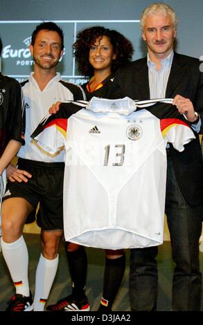 (Dpa) Der Trainer der deutschen Fußball-Nationalmannschaft, präsentiert Rudi Voeller (rechts / mit Hemd) mit verschiedenen Modellen der neuen Fußball-Trikots der deutschen Fußball-Nationalmannschaft auf Donnerstag, 25. März 2004 in Gravenbruch bei Frankfurt. Stockfoto