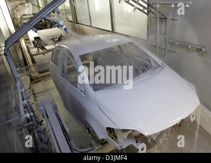 (Dpa) - die Kutschen von Volkswagen (VW) Golf Plus Modell bewegen sich auf einem Förderband durch den automatisierten Lack Veredelung Station im Montagewerk für VW in Wolfsburg, Deutschland, 22 Februar 2005. VW beschäftigt 103800 Arbeitnehmer in Deutschland von denen um 50200 Arbeit an die Hauptproduktionsstätte in Wolfsburg. Stockfoto