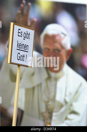 (Dpa) - vor einem Bild des Papstes ein Schild mit der Aufschrift "Es gibt keinen Gott" wird vor dem Dom in Köln, Deutschland, Freitag, 19. August 2005 angehoben. Die katholische Jugend der Welt trifft der erste deutsche Führer der katholischen Kirche in 500 Jahren. 400.000 Pilger aus 193 Ländern kommen nach der 20. Weltjugendtag läuft vom 16. August bis 21. August in Köln Stockfoto