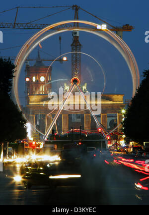 (Dpa) - das Bild zeigt ein Riesenrad drehen vor dem Brandenburger Tor in Berlin, Deutschland, späten Sonntag, 2. Oktober 2005. Nach Polizeiberichten, rund 10.000 Besucher noch zeigte sich bei dem Volksfest anlässlich der Feierlichkeiten von der deutschen Vereinigung Dax am 3. Oktober. das Festival mit Musikunterhaltung, Spiele und Fahrten läuft bis zum späten Montag Stockfoto