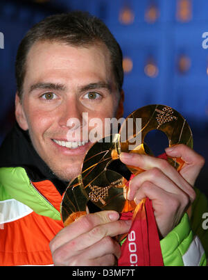 nach der Siegerehrung auf der Medal Plaza in Turin, Italien, 25. Februar 2006 präsentiert (Dpa) - deutscher Biathlet Michael Greis seine drei Goldmedaillen. Greiss hinzugefügt, um seine 20km und Staffel gold Medaillen mit einige komponierten Aufnahmen und leistungsstarke Skifahren um die Männer 15-Kilometer-Rennen zu gewinnen. Foto: Martin Schutt Stockfoto