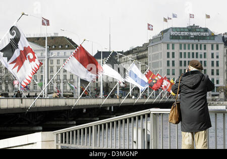 Ein Tourist nimmt ein Bild von der Pont du Mont-Blanc-Brücke, geschmückt mit Fahnen in Genf, Schweiz, 2. März 2006. Foto: Marijan Murat Stockfoto