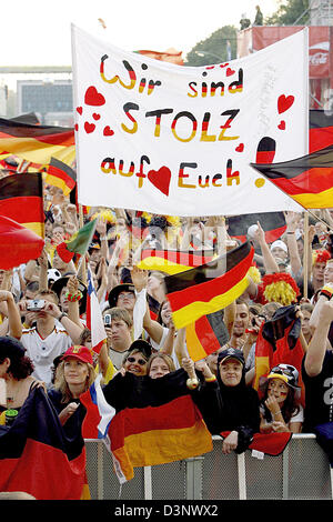 Anhänger der deutschen Nationalmannschaft Welle passen ihre Flaggen vor den 3. Platz der FIFA-WM 2006 zwischen Deutschland und Portugal auf der Fanmeile in Berlin, Deutschland, Samstag, 8. Juli 2006. Foto: Marcel Mettelsiefen Stockfoto