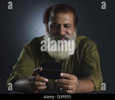 Mann liest eine SMS auf dem Handy Stockfoto