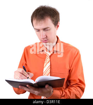 Der junge Geschäftsmann mit dem täglichen log Stockfoto