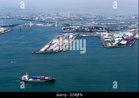 Luftaufnahme des Osakas Sakishima Nanko Insel Hafengebiet mit einem Containerschiff vorbei durch die ausländischen Zugang Zone (FAZ). Stockfoto