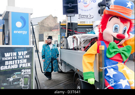 London, UK - 24. Februar 2013: ein Mann der Stamford Hill orthodoxen jüdischen Gemeinde hält seinen LKW während der Feierlichkeiten des Purim 2013 zu tanken. Gekleidet im Kostüm Männer aus der Gemeinde tanzen und singen in den Straßen auf den Klang sehr laut jiddischer Musik, Besuch von wohlhabenden Geschäftsleuten Geld zu sammeln. Stockfoto