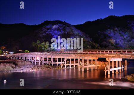 Die historische Togetsukyo Bridge, beleuchtet in der Nacht in der Arashiyama von Kyoto, Japan. Stockfoto