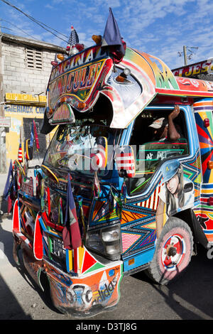 Klapses Busse vorbei durch die Innenstadt von Port-au-Prince. -Klapses Fahrzeuge dienen als öffentliche Verkehrsmittel in Haiti. Stockfoto