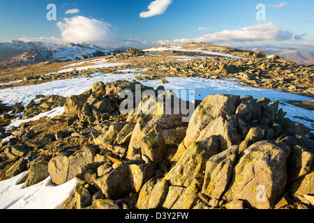 Flechten bedeckt Felsen am wirbeln Howe über Wrynose in der Seenplatte, Cumbria, UK, mit Blick auf Langdale und Scafell Stockfoto