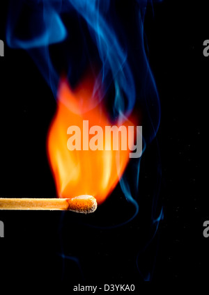 bunte Flamme mit hölzernen Streichholz, isoliert auf schwarz Stockfoto