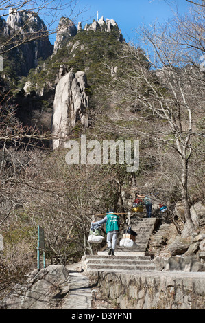 Träger mit Lieferungen in Richtung Gipfel des Huangshan, Anhui Provinz, China Stockfoto