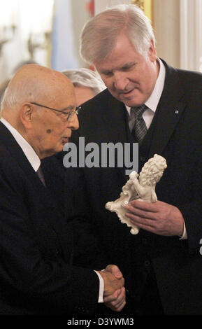 München, Deutschland. 26. Februar 2013. Italienische Präsident Giorgio Napolitano (L) erhält eine kleine Löwe Skulptur als Geschenk vom Bayerischen Premier Horst Seehofer (CSU) im Rahmen eines Empfangs am national Theatre. Napolitano ist zum Staatsbesuch nach Deutschland. Foto: Frank Leonhardt/Dpa/Alamy Live News Stockfoto