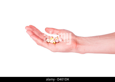 Männliche Hand hält eine Handvoll medizinische Pillen isoliert auf weiss. Stockfoto