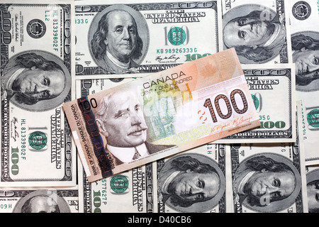 100 kanadische Dollar Banknote mit Sir Robert Borden und 100 US-Dollar-Banknoten als Hintergrund Stockfoto