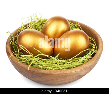 goldene Ostereier in Schüssel isoliert Stockfoto