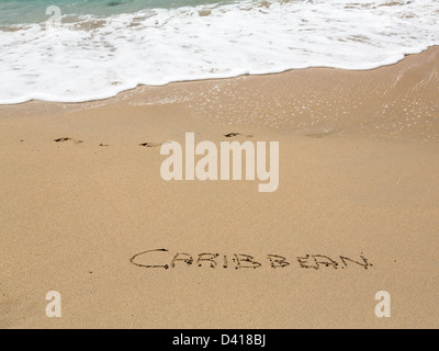 Karibische Worte geschrieben in Sand am Strand vom Meer in St. Thomas Stockfoto