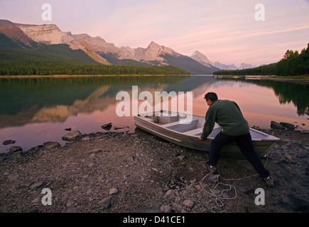 Mittleren Alters, Männlich hochziehen Ruderboot am Ufer am Maligne Lake, Jasper Nationalpark, Alberta, Kanada. Stockfoto